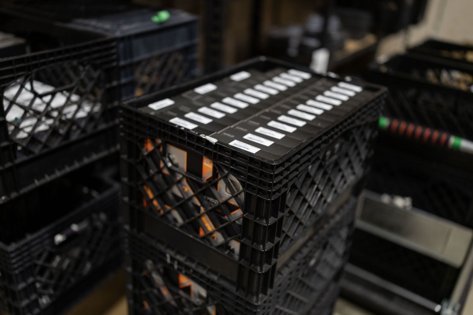 Stacked crates of GPU brackets and components staged for assembly.